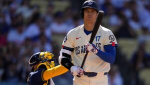 Los Angeles Dodgers' Shohei Ohtani, right, steps away from the plate after taking a strike as Milwaukee Brewers catcher William Contreras throws the ball back during the first inning of a baseball game Saturday, Aug. 15, 2026, in Los Angeles. (AP Photo/Mark J. Terrill)