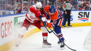 Edmonton Oilers' Shakir Mukhamadullin (85) defends against Detroit Red Wings' Dylan Larkin (71) during first period NHL hockey action in Edmonton on Monday, Oct. 26, 2026. (Codie McLachlan/CP)