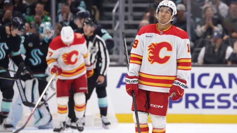 Calgary Flames defenseman Zayne Parekh (19) skates off after a stop in play during the third period of an NHL hockey game against the Seattle Kraken Sunday, Oct. 4, 2026, in Seattle. (AP Photo/Jason Redmond)