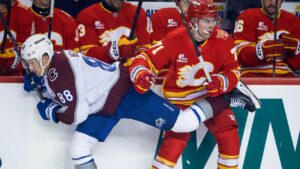 Colorado Avalanche's Martin Necas, left, is checked by Calgary Flames' Simon Nemec during first period NHL hockey action in Calgary on Thursday, Oct. 8, 2026. (Jeff McIntosh/CP)