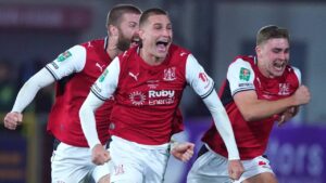 Fleetwood's players celebrate after winning a penalty shootout during the English League Cup soccer match between Fleetwood Town and Arsenal in Fleetwood, England, Tuesday, Oct. 27, 2026. (Ian Hodgson/AP)