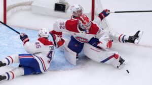 Montreal Canadiens goaltender Jacob Fowler (32) deflects a puck as teammates Alexandre Carrier (45) and Adam Engstrom (42) get in on the play during the third period of an NHL hockey game against the St. Louis Blues Tuesday, Oct. 27, 2026, in St. Louis. (AP Photo/Jeff Roberson)