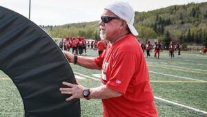 Calgary Stampeders equipment manager George Hopkins moves training gear during the first of training camp in Calgary, Sunday, May 11, 2025. Hopkins has been on the Stampeders staf for over 50 years. (Jeff McIntosh/CP)