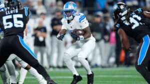Detroit Lions running back Jahmyr Gibbs (0) runs the ball during an NFL football game against the Carolina Panthers in Charlotte, N.C., Sunday, Oct. 4, 2026. (AP Photo/Erik Verduzco)