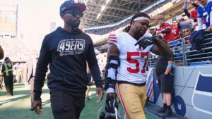 San Francisco 49ers linebacker Dre Greenlaw (57) leaves the field after being ejected during the first half of an NFL football game against the Seattle Seahawks, Sunday, Oct. 11, 2026, in Seattle. (AP Photo/Lindsey Wasson)