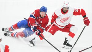 Montreal Canadiens' Mike Matheson (8) and Detroit Red Wings' Keegan Kolesar (55) vie for the puck during first period NHL hockey action in Montreal on Saturday, Oct. 10, 2026.  (Graham Hughes/CP)