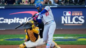 Los Angeles Dodgers left fielder Teoscar HernÃ¡ndez connects for an RBI sacrifice fly during the first inning of Game 2 of baseball's National League Championship Series between the Milwaukee Brewers and the Los Angeles Dodgers, Monday, Oct. 12, 2026, in Milwaukee. (Kayla Wolf/AP)