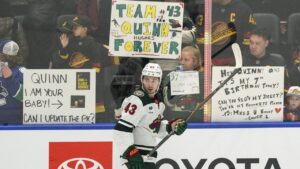 Fans watch as Minnesota Wild’s Quinn Hughes (43) participates in the pre-game skate before an NHL game against his former team, the Vancouver Canucks, in Vancouver, on Sunday, Oct. 25, 2026. (Jacob Mallari/CP)