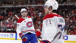 Montreal Canadiens center Kirby Dach, left, celebrates with center Jake Evans (71) after Evans scored during the first period of an NHL hockey game against the Chicago Blackhawks, Friday, Oct. 23, 2026, in Chicago. (Jessie Alcheh/AP)