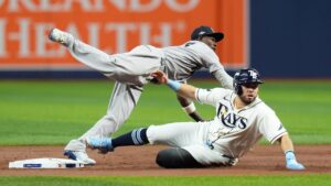 Tampa Bay Rays' Jonathan Aranda, right, is out at second as New York Yankees second baseman Jazz Chisholm Jr., left, commits a throwing error allowing Rays' Yandy Díaz to score during the first inning in Game 2 of an American League Division Series baseball game Monday, Oct. 5, 2026, in St. Petersburg, Fla. (Chris O'Meara/AP)