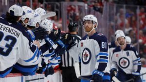 Winnipeg Jets left wing Kyle Connor (81) celebrates his goal against the Detroit Red Wings with teammates during the first period of an NHL hockey game Sunday, Oct. 4, 2026, in Detroit. (Duane Burleson/AP)
