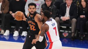 New York Knicks' Karl-Anthony Towns (32) protects the ball from Detroit Pistons' Paul Reed (7) during the first half of an NBA basketball game Tuesday, Oct. 27, 2026, in New York. (Frank Franklin II/AP)