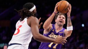 Los Angeles Lakers guard Luka Doncic, right, shoots as LA Clippers forward Isaiah Jackson defends during the first half of an NBA basketball game Friday, Oct 23, 2026, in Los Angeles. (AP Photo/Mark J. Terrill)