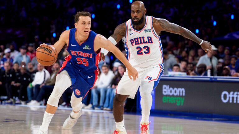 Detroit Pistons' Duncan Robinson, left, drives to the basket against Philadelphia 76ers' LeBron James, right, during the first half of an NBA basketball game, Sunday, Oct. 25, 2026, in Philadelphia. (AP Photo/Chris Szagola)