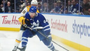 Toronto Maple Leafs' Morgan Rielly (44) protects the puck from Nashville Predators' Steven Stamkos (91) during first period NHL hockey action in Toronto on Tuesday, Oct. 6, 2026. (Nathan Denette/CP)