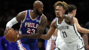 Philadelphia 76ers' LeBron James (23) looks to pass the ball against Brooklyn Nets' Noah Clowney (21) during the first half of a preseason NBA basketball game Thursday, Oct. 8, 2026, in New York. (AP Photo/Pamela Smith)