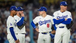 From left: Los Angeles Dodgers shortstop Mookie Betts, third baseman Max Muncy, third baseman Kiké Hernández, and first baseman Freddie Freeman stand together during a pitching change during the fourth inning of Game 4 of baseball's National League Championship Series between the Milwaukee Brewers and the Los Angeles Dodgers, Thursday, Oct. 15, 2026, in Los Angeles. (Gregory Bull/AP)