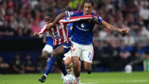 Manchester United's Leny Yoro, right, fouls Atletico Madrid's Jonathan David during the Champions League opening phase soccer match between Atletico Madrid and Manchester United in Madrid, Tuesday, Oct. 13, 2026. (AP Photo/Bernat Armangue)