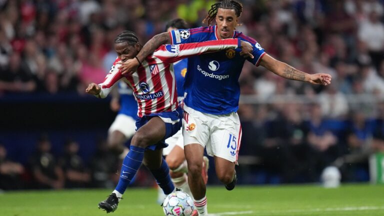 Manchester United's Leny Yoro, right, fouls Atletico Madrid's Jonathan David during the Champions League opening phase soccer match between Atletico Madrid and Manchester United in Madrid, Tuesday, Oct. 13, 2026. (AP Photo/Bernat Armangue)