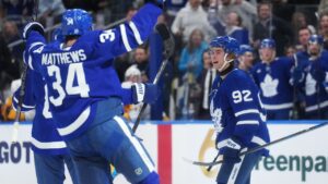 Toronto Maple Leafs' Gavin McKenna (92) celebrates his goal against the Nashville Predators with Auston Matthews (34) during second period NHL hockey action in Toronto on Tuesday, Oct. 6, 2026. (Nathan Denette/CP)