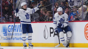 Toronto Maple Leafs left wing Gavin McKenna (92) celebrates with center Auston Matthews (34) after he scored a goal against the Colorado Avalanche in the third period of an NHL hockey game Saturday, Oct. 10, 2026, in Denver. (David Zalubowski/AP)