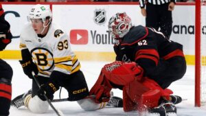 Carolina Hurricanes goaltender Pyotr Kochetkov (52) battles with Boston Bruins' Fraser Minten (93) for position during the first period of an NHL hockey game in Raleigh, N.C., Tuesday, Oct. 27, 2026. (Karl DeBlaker/AP)