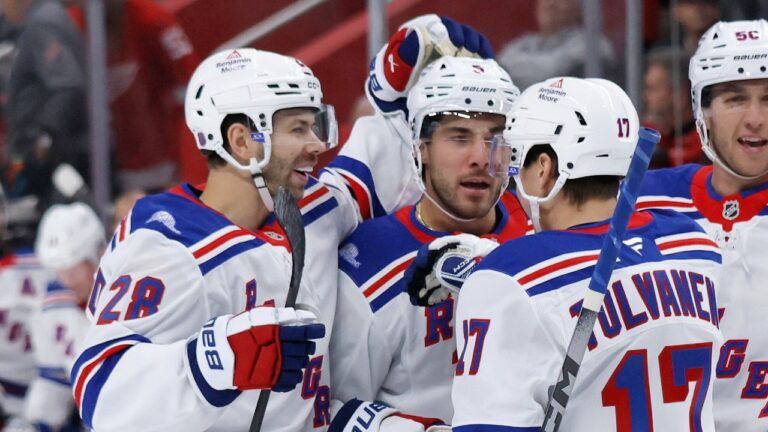 New York Rangers defenseman Sean Durzi, center, celebrates with right wing Oliver Bjorkstrand (28) and right wing Eeli Tolvanen (17) after scoring against the Detroit Red Wings during the first period of an NHL hockey game Friday, Oct. 2, 2026, in Detroit. (Duane Burleson/AP)