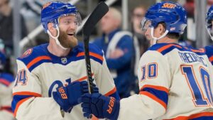 Edmonton Oilers defenceman Mattias Ekholm (14) celebrates with center Trent Frederic (10) after scoring a goal against the San Jose Sharks during the first period of an NHL hockey game in San Jose, Calif., Saturday, Oct. 10, 2026. (Tony Avelar/AP)