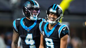 Carolina Panthers quarterback Bryce Young (9) and Carolina Panthers wide receiver Tetairoa McMillan (4) celebrate a touchdown during an NFL football game against the Detroit Lions in Charlotte, N.C., Sunday, Oct. 4, 2026. (AP Photo/Erik Verduzco)