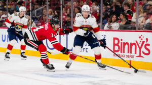 Florida Panthers centre Anton Lundell (15) controls the puck against Chicago Blackhawks defenceman Kevin Korchinski (14) during the first period of an NHL hockey game, Sunday, Oct. 25, 2026, in Chicago. (Harry Figiel/AP)