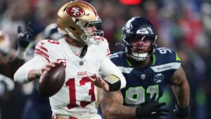 San Francisco 49ers quarterback Brock Purdy (13) looks to throw during the second half of an NFL football divisional playoff game against the Seattle Seahawks, Saturday, Jan. 17, 2026, in Seattle. (Lindsey Wasson/AP)