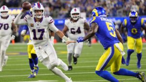 Buffalo Bills quarterback Josh Allen, left, runs the ball as Los Angeles Rams safety Kamren Kinchens defends during the second half of an NFL football game, Monday, Oct. 12, 2026, in Inglewood, Calif. (AP Photo/Gregory Bull)