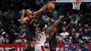 Washington Wizards guard Tre Johnson (12) has his shot blocked by Toronto Raptors forward Scottie Barnes (4) during the first half of an NBA basketball game in Washington, Friday, Oct. 23, 2026. (AP Photo/Terrance Williams)