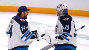 Winnipeg Jets goaltenders Clay Stevenson (33) and Stuart Skinner celebrate at the end of an NHL hockey game against the Pittsburgh Penguins in Pittsburgh, Monday, Oct. 5, 2026. (Gene J. Puskar/AP)