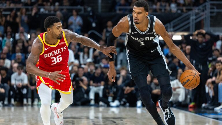 Houston Rockets guard Marcus Smart (36) defends San Antonio Spurs forward Victor Wembanyama (1) during the first half of an NBA basketball game in Austin, Texas, Friday, Oct. 23, 2026. (AP Photo/Stephen Spillman)