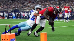 Tampa Bay Buccaneers running back Bucky Irving (7) gets past Dallas Cowboys defensive back Reddy Steward (27) for a touchdown in the first half of an NFL football game in Arlington, Texas on Thursday, Oct. 8, 2026. (Julio Cortez/AP)