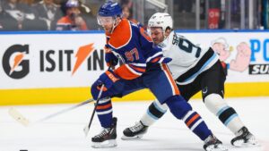 Edmonton Oilers' Connor McDavid (97) protects the puck from Utah Mammoth's Mikhail Sergachev (98) during second period NHL hockey action in Edmonton on Thursday, Oct. 15, 2026. (Codie McLachlan/CP)