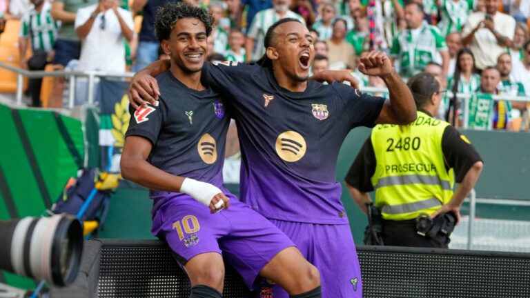 Barcelona's Lamine Yamal, left, celebrates with Barcelona's Jules Kounde after scoring his side's opening goal during the Spanish La Liga soccer match between Real Betis and Barcelona in Seville, Spain, Saturday, Oct. 17, 2026. (Jose Breton/AP)