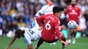 Manchester United's Lisandro Martinez, right, and Leeds United's Dominic Calvert-Lewin battle for the ball during the English Premier League soccer match between Leeds United and Manchester United in Leeds, England, Sunday, Oct. 18, 2026. (Annabel Lee-Ellis/AP)