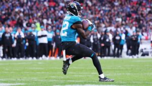 Jacksonville Jaguars wide receiver Travis Hunter (12) catches a touchdown during a NFL football game against the Houston Texans in London, Tuesday, Oct. 13, 2026. (Adam Bettcher/AP)