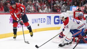 Washington Capitals left wing Alex Ovechkin (8) passes the puck against Montreal Canadiens center Phillip Danault (24) during the first period of an NHL hockey game, Wednesday, Oct. 14, 2026, in Washington. (AP Photo/Nick Wass)