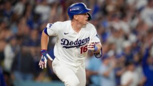 Los Angeles Dodgers catcher Will Smith follows runs on his two RBI double during thesixth inning of Game 3 of baseball's National League Championship Series between the Milwaukee Brewers and the Los Angeles Dodgers, Wednesday, Oct. 14, 2026, in Los Angeles. (AP Photo/Gregory Bull)