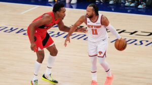 Toronto Raptors' Scottie Barnes, left, defends New York Knicks' Jalen Brunson during the first half of a preseason NBA basketball game Thursday, Oct. 15, 2026, in New York. (AP Photo/Frank Franklin II)