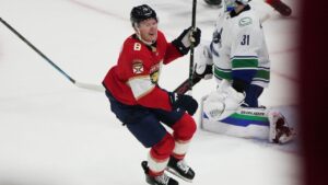 Florida Panthers left wing Brady Tkachuk (8) celebrates after scoring the game winning goal against Vancouver Canucks goaltender Leevi Meriläinen (31) during overtime in an NHL hockey game, Thursday, Oct. 15, 2026, in Sunrise, Fla. (AP Photo/Lynne Sladky)
