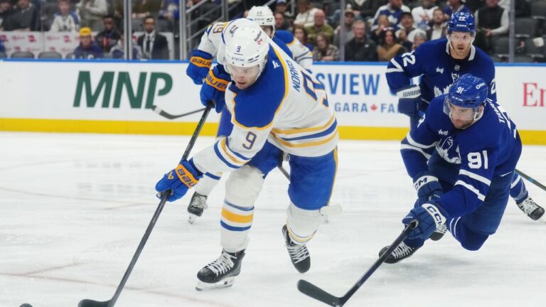 Buffalo Sabres' Josh Norris (9) and Toronto Maple Leafs' John Tavares (91) battle for a rebound during third period NHL hockey action in Toronto on Thursday, Oct. 15, 2026. THE CANADIAN PRESS/Nathan Denette
