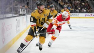 Vegas Golden Knights center Jack Eichel (9) skates around Calgary Flames defenseman Jake Middleton (55) during the second period of an NHL hockey game Thursday, Oct. 15, 2026, in Las Vegas. (AP Photo/John Locher)