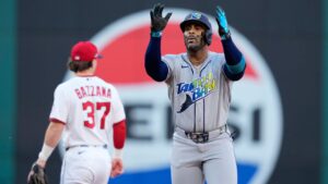 Tampa Bay Rays' Yandy Díaz celebrates a double against the Cleveland Guardians during the first inning in Game 5 of an American League Championship Series baseball game in Cleveland, Sunday, Oct. 18, 2026. (AP Photo/David J. Phillip)