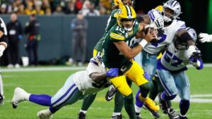 Dallas Cowboys' Quinnen Williams tries to stop Green Bay Packers' Jordan Love during the first half of an NFL football game in Green Bay, Wis., Sunday, Oct. 18, 2026. (AP Photo/Mike Roemer)