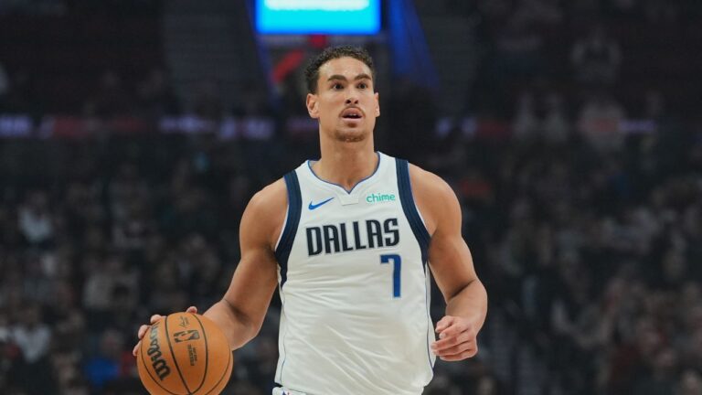 Dallas Mavericks forward/center Dwight Powell (7) dribbles during the first half of an NBA basketball game against the Portland Trail Blazers, Friday, March 27, 2026, in Portland, Ore. (AP Photo/Jenny Kane)