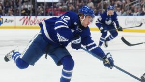 Toronto Maple Leafs' Gavin McKenna (92) shoots as Buffalo Sabres' Owen Power (25) defends during second period NHL hockey action in Toronto on Thursday, Oct. 15, 2026. THE CANADIAN PRESS/Nathan Denette